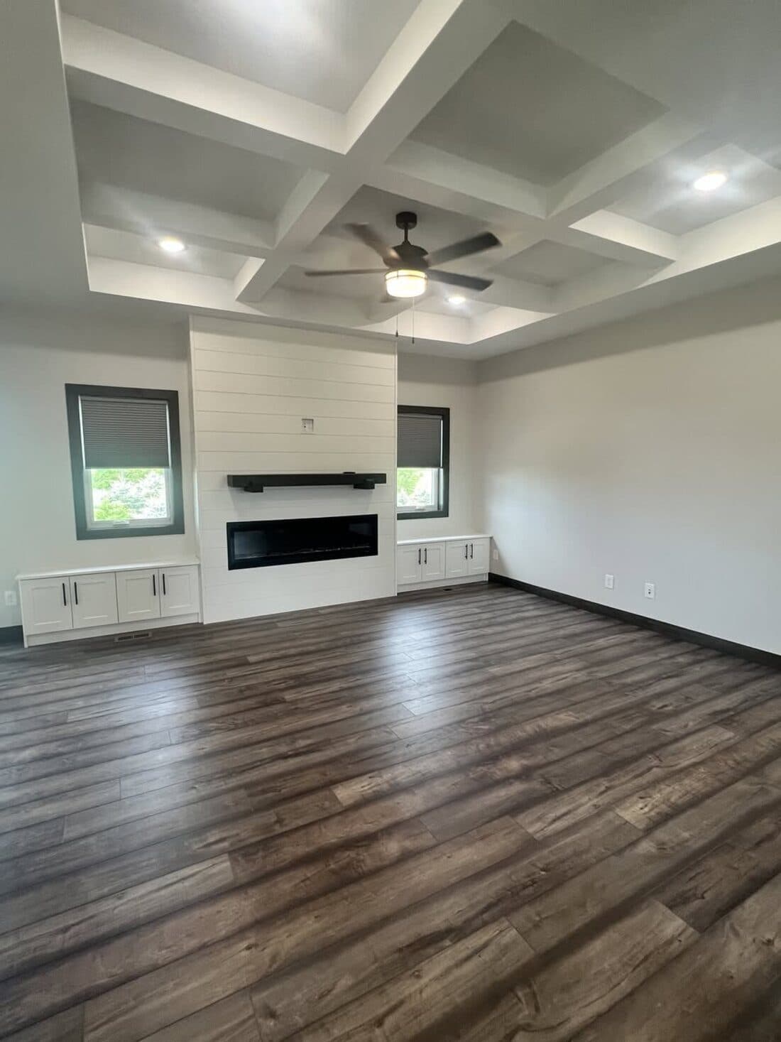 New-construction great room interior with a coffered ceiling