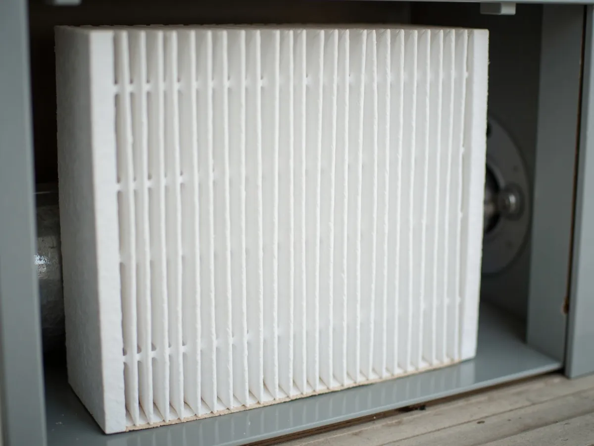 Clean pleated air filter seated in the filter rack of a return-air housing