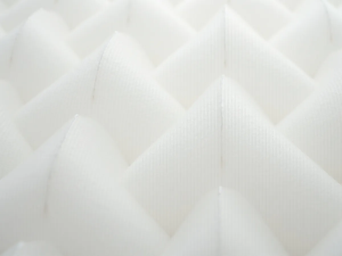 Macro photograph of white pleated air filter media